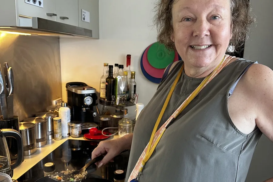 A participant cooking a meal in the kitchen