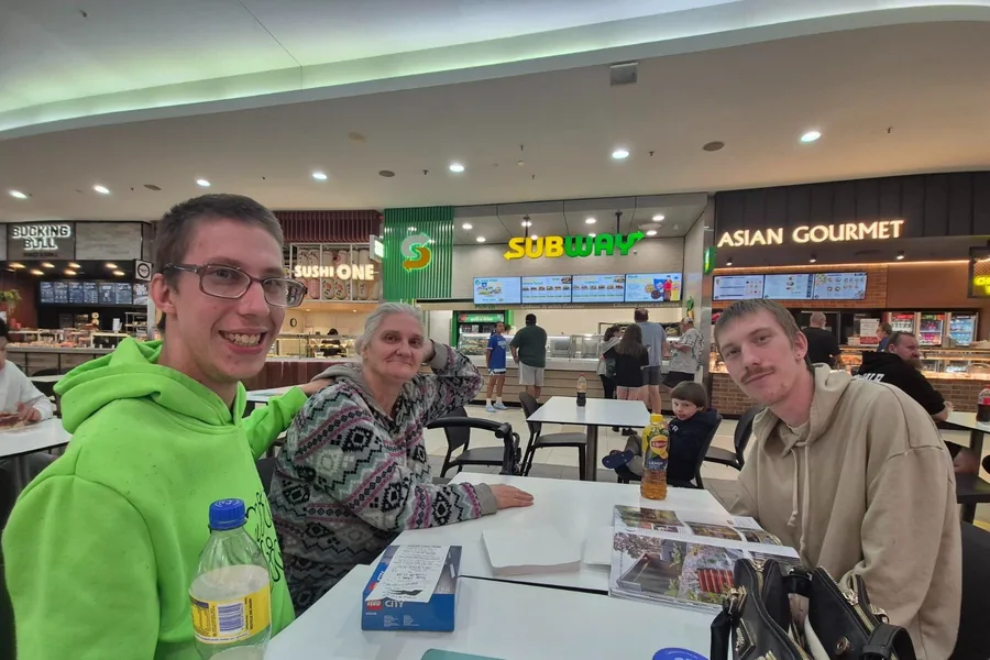 A group having lunch together at a shopping centre food court